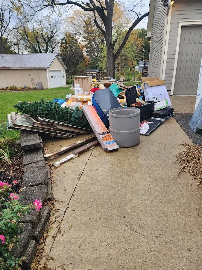 Dumpster being loaded with debris for Estate Cleanout Dumpster Rental in Montrose